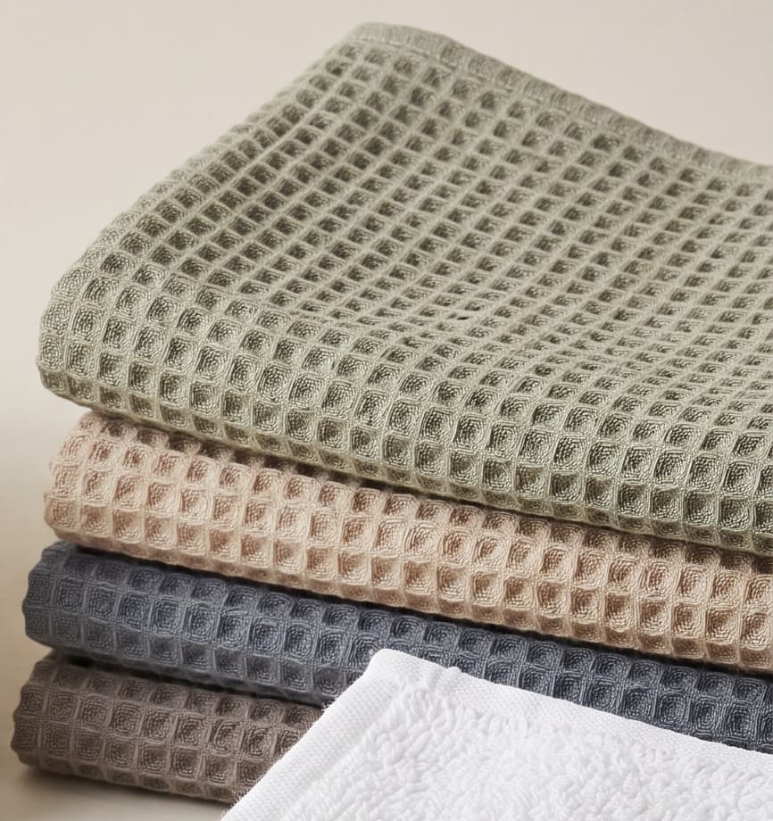 Folded waffle-weave cloths in sage, taupe and grey